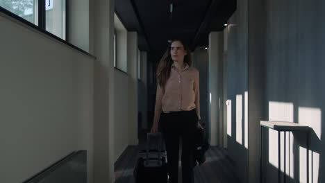 Business-woman-walking-at-hotel-corridor.-Businesswoman-arriving-in-hotel