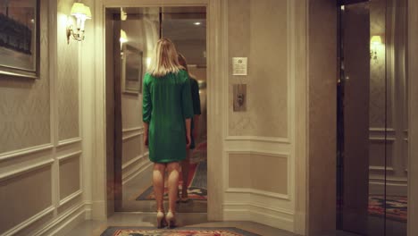 Young-woman-coming-into-elevator-car-and-lift-doors-closing