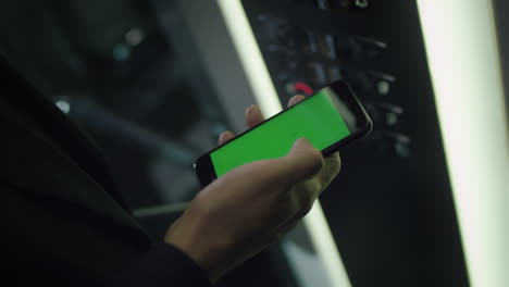 Man-touching-mobile-smart-phone-with-chroma-key-green-screen