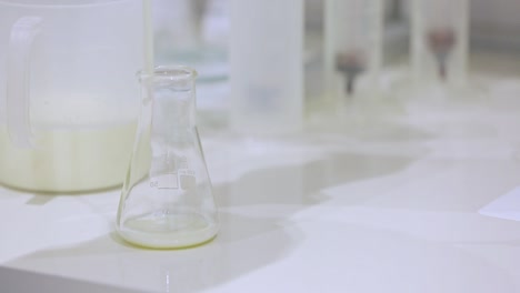 Milk-testing-in-lab-flask.-Food-quality-control.-Analysis-of-milk-sample