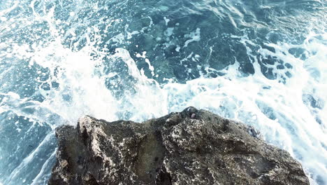 Sea-wave-crashing-on-rock-coast-pov.-Blue-ocean-breaking-waves.
