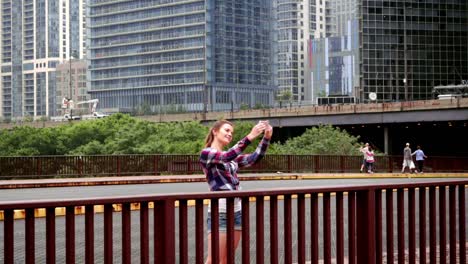 Woman-making-selfie.-Brunette-woman-taking-selfie-photo-in-cityscape