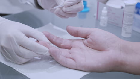 Finger-blood-test.-Doctor-doing-blood-analysis.-doctor-hands-using-lancelet