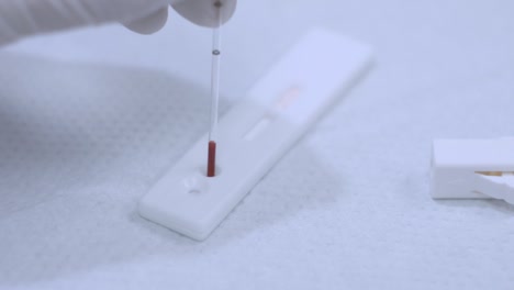 Blood-sample-drop-to-analyzer.-Closeup-of-blood-test-process