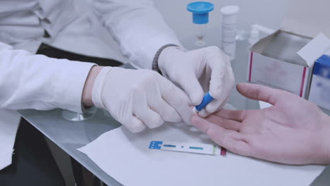 Doctor-taking-blood-sample-from-male-hand.-Man-donate-blood-finger-test