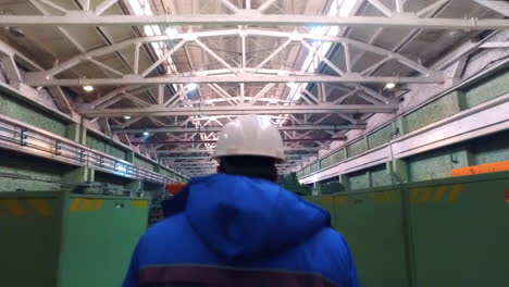 Worker-walking-in-workshop-of-steel-factory.-Engineer-walking-at-metal-factory