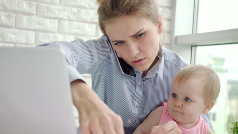 Business-woman-with-baby-speaking-phone.-Business-mother-working