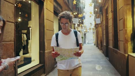 Man-tourist-searching-way-with-map.-Focused-student-looking-correct-road