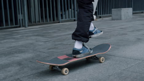 Unrecognizable-skater-balancing-on-board-outdoor.-Man-feet-running-outside.