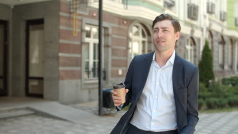 Closeup-businessman-going-to-work-with-coffee-.-Man-going-to-job-with-drink