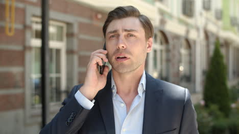 Portrait-man-talking-on-phone-about-work.-Serious-businessman-calling-partner
