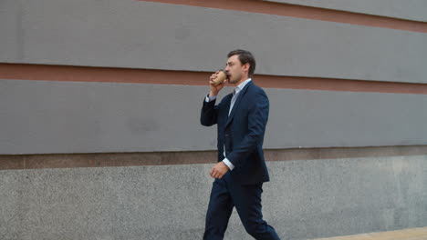 Side-view-business-man-drinking-coffee-to-go.-Man-drinking-take-away-coffee