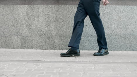 Business-man-legs-dancing-at-street.-Closeup-shoes-dancing-outdoor-near-building