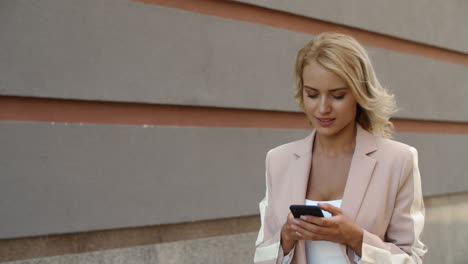Closeup-woman-texting-message-on-phone.-Businesswoman-using-phone-at-street