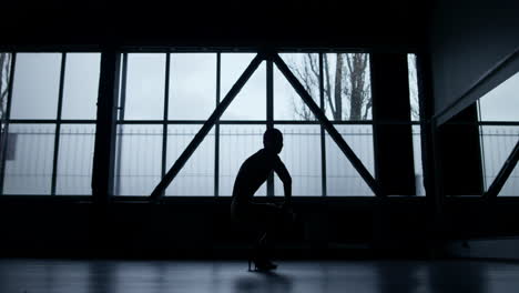 Woman-silhouette-doing-aerobics-indoors.-Unknown-dancer-having-workout-in-class
