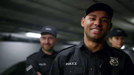 Policeman-smiling-at-camera.-Positive-cop-in-uniform-posing-at-camera