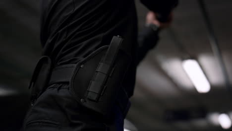 Policeman-taking-gun-from-holster.-Police-officer-aiming-pistol