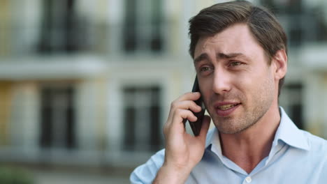Portrait-serious-man-having-phone-talk.-Angry-businessman-talking-on-smartphone