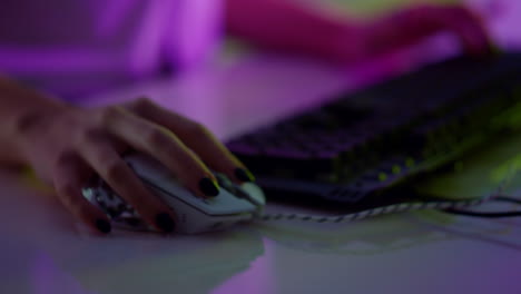 Gamer-hands-typing-keyboard-in-neon-cyberspace-closeup.-Video-gaming-club-night.