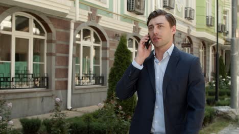 Business-man-talking-phone-at-street.-Businessman-discussing-business-outdoor