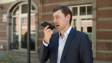 Closeup-businessman-talking-phone-outdoor.-Businessman-having-phone-conversation