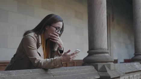Student-reading-bad-news-on-phone.-Businesswoman-using-smartphone-outdoors