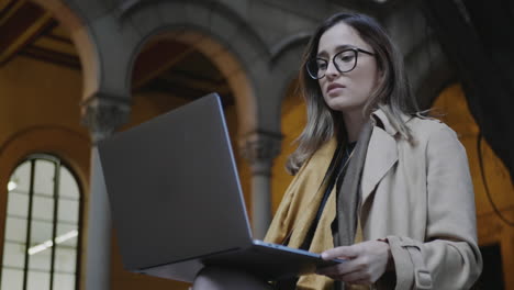 Student-reading-bad-news-on-laptop-screen-at-college.-Businesswoman-using-laptop