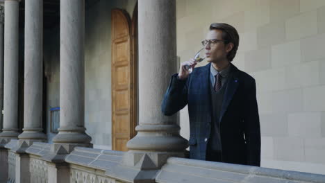 Student-drinking-champagne-in-hallway-.Businessman-drinking-champagne-outdoors