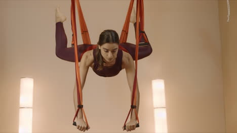 Woman-doing-split-in-hammock-at-class.-Sportswoman-practicing-antigravity-yoga