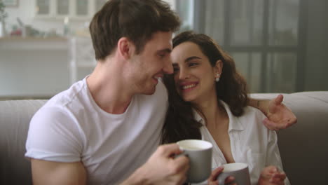 Happy-couple-relaxing-with-coffee-at-home.-Young-married-couple-drinking-coffee