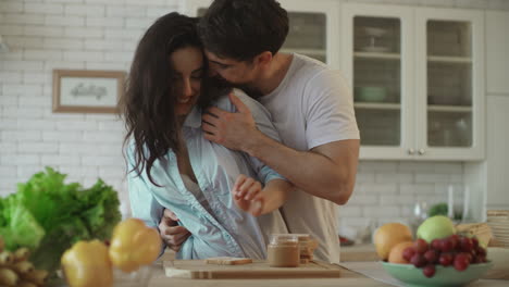 Lovely-couple-flirting-at-home.-Sensual-woman-flirting-with-man-at-kitchen