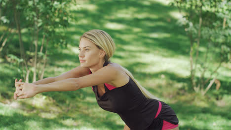 Sport-woman-doing-warm-up-exercise-before-workout-outdoor.-Fit-woman-stretching