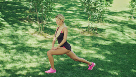 Young-woman-doing-stretching-squat-while-warm-up-before-training.-Fitness-woman
