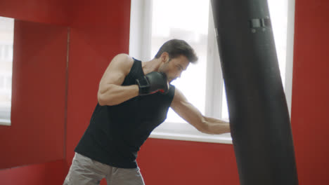 Sportler-Schlägt-Boxsack-Beim-Kampftraining.-Kickboxer-Training-Im-Kampfclub