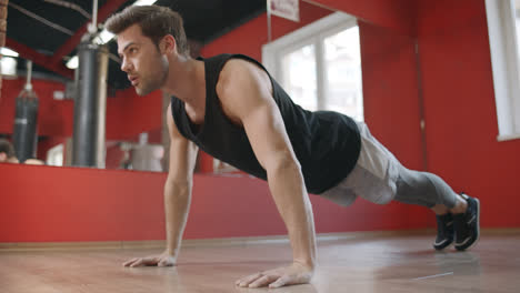Athlete-man-training-push-up-exercise-in-fitness-club.