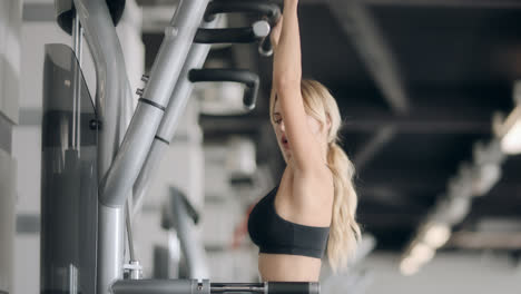 Fitness-girl-doing-pull-ups-exercises-in-modern-gym.