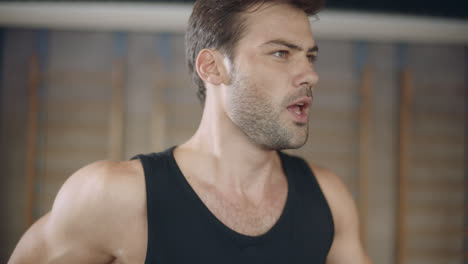 Closeup-handsome-man-running-on-treadmill-machine-in-fitness-club.