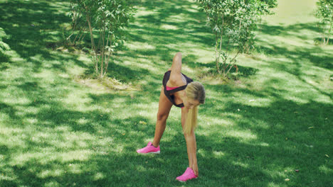 Sport-woman-doing-stretching-exercise-during-workout-in-summer-park.-Fit-woman