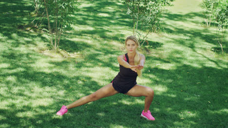 Fitness-woman-doing-stretching-squat.-Fit-girl-warming-up-before-sport-training