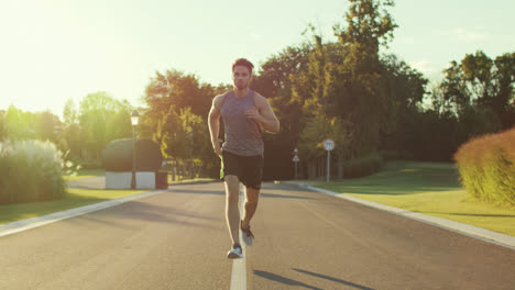 Fitness-man-jogging-in-park-at-summer-morning.-Sport-man-training-run