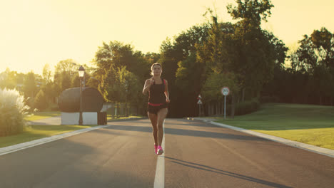 Sport-woman-running-in-park-at-sunset.-Female-runner-training-run-outdoor