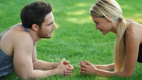 Young-couple-flirting-at-fitness-workout-outdoor.-Fitness-man-talking-with-woman