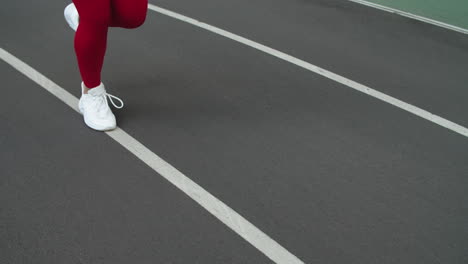 Close-up-of-sport-woman-legs-running-at-stadium.-Woman-feet-running-in-shoes
