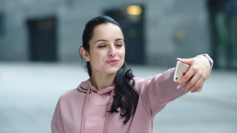 Closeup-cheerful-woman-posing-for-selfie-photo.-Happy-woman-showing-victory-sign