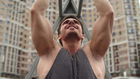 Close-up-of-athlete-man-working-out-outdoor.-Fitness-guy-doing-pull-ups