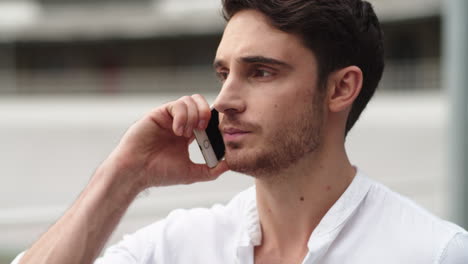 Close-up-man-having-conversation-on-phone.-Man-having-phone-talk-about-work
