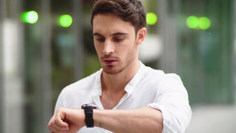 Closeup-man-checking-notifications-on-smart-watch.-Guy-using-digital-watch