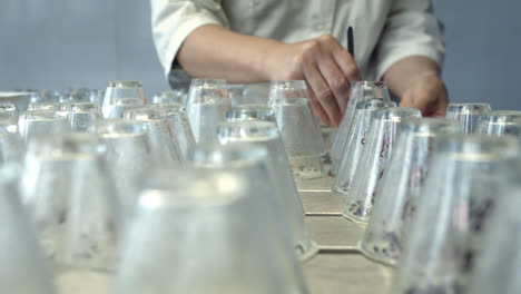 Scientist-preparing-laboratory-glassware-on-table-for-carring-out-experiments