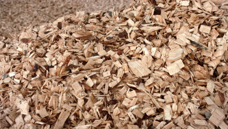 Sawdusts-falling-into-heap-during-process-of-woodworking.-Wooden-sawdust