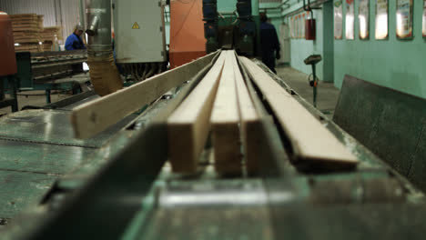 Prozess-Des-Sägens-Von-Kiefernstämmen-Auf-Stangen.-Industrieausrüstung-Für-Die-Holzverarbeitung